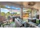 Relaxing screened patio with wicker furniture and fire pit overlooking pool at 10177 Sunburst Ct, Spring Hill, FL 34608