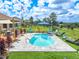 Relaxing kidney-shaped pool with surrounding patio at 10177 Sunburst Ct, Spring Hill, FL 34608