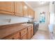 Bright laundry room with washer, dryer, and built-in cabinets at 10177 Sunburst Ct, Spring Hill, FL 34608