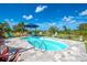 Kidney-shaped swimming pool with plenty of lounge chairs at 10177 Sunburst Ct, Spring Hill, FL 34608
