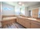 Elegant main bathroom with a large soaking tub and double vanity at 10177 Sunburst Ct, Spring Hill, FL 34608