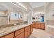 Elegant bathroom with double vanity, soaking tub, and walk-in shower at 435 Westwinds Drive, Palm Harbor, FL 34683