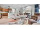 Open living room and kitchen with hardwood floors, neutral tones, and comfortable furniture at 435 Westwinds Drive, Palm Harbor, FL 34683