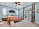 Bright main bedroom with a king-size bed, private access to a balcony, and an ensuite bathroom at 435 Westwinds Drive, Palm Harbor, FL 34683
