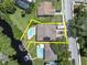 Aerial view of waterfront home with private pool and dock at 435 Westwinds Drive, Palm Harbor, FL 34683