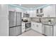 Modern kitchen with stainless steel appliances and white shaker cabinets at 650 Pinellas Point S Dr # 106, St Petersburg, FL 33705