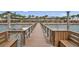 Wooden community pier with benches offering scenic views at 650 Pinellas Point S Dr # 106, St Petersburg, FL 33705