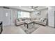 Living room featuring a sectional sofa and a large window at 650 Pinellas Point S Dr # 106, St Petersburg, FL 33705