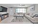Living room with beige sectional sofa and coffee table at 650 Pinellas Point S Dr # 106, St Petersburg, FL 33705