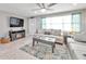 Spacious living area featuring a comfy couch and a large TV at 650 Pinellas Point S Dr # 106, St Petersburg, FL 33705
