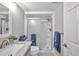 Updated bathroom with shower, vanity and modern fixtures at 650 Pinellas Point S Dr # 106, St Petersburg, FL 33705