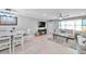 Bright living room with light beige couch and fireplace at 650 Pinellas Point S Dr # 106, St Petersburg, FL 33705