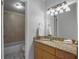 Bathroom with wood cabinets, granite countertop, and a bathtub at 200 Country Club Dr # 1004, Largo, FL 33771