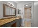 Bathroom with granite countertop, gray cabinets, and a shower/tub combo at 200 Country Club Dr # 1004, Largo, FL 33771