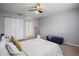 Primary bedroom with a queen-size bed and blue ottoman at 200 Country Club Dr # 1004, Largo, FL 33771