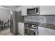 Modern kitchen with stainless steel appliances and granite countertops at 200 Country Club Dr # 1004, Largo, FL 33771
