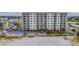 Building exterior, pool, and beachfront view at 13500 Gulf Blvd # 605, Madeira Beach, FL 33708