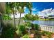 Landscaped backyard with a bird bath and lake view at 903 San Carlos Ne Ave, St Petersburg, FL 33702