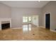 Open living room with tile floors, fireplace and view to sunroom at 903 San Carlos Ne Ave, St Petersburg, FL 33702