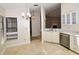 Bright kitchen features white cabinets, granite countertops, and tile floors at 903 San Carlos Ne Ave, St Petersburg, FL 33702
