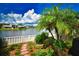 Backyard with lush landscaping and lake view at 903 San Carlos Ne Ave, St Petersburg, FL 33702