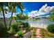 Landscaped backyard oasis with lake view and a stone path at 903 San Carlos Ne Ave, St Petersburg, FL 33702