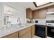 Kitchen with wood cabinets, double sink, and a dishwasher at 320 Windrush Blvd # 4, Indian Rocks Beach, FL 33785
