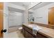 Clean bathroom with tub and wood vanity at 320 Windrush Blvd # 4, Indian Rocks Beach, FL 33785