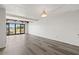 Spacious living room with wood floors and sliding doors to balcony at 320 Windrush Blvd # 4, Indian Rocks Beach, FL 33785