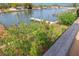 Scenic waterfront view with private dock and lush landscaping at 320 Windrush Blvd # 4, Indian Rocks Beach, FL 33785