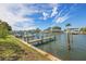 Private boat dock on calm waters with neighboring homes visible at 320 Windrush Blvd # 4, Indian Rocks Beach, FL 33785