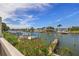 Scenic view of canal with boats and lush foliage at 320 Windrush Blvd # 4, Indian Rocks Beach, FL 33785