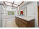Kitchen with wood cabinets, breakfast bar, and access to living area at 320 Windrush Blvd # 4, Indian Rocks Beach, FL 33785