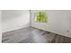 Simple bedroom with window and grey laminate floors at 320 Windrush Blvd # 4, Indian Rocks Beach, FL 33785