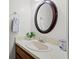 Simple bathroom with an oval mirror and vanity at 320 Windrush Blvd # 4, Indian Rocks Beach, FL 33785