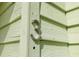 Close up of house number 3 on light green siding at 320 Windrush Blvd # 4, Indian Rocks Beach, FL 33785