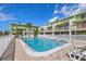 Inviting community pool with ample lounge chairs at 320 Windrush Blvd # 4, Indian Rocks Beach, FL 33785