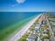 Aerial view of beachfront property, showcasing homes and ocean at 320 Windrush Blvd # 4, Indian Rocks Beach, FL 33785