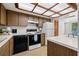 Modern kitchen with wood cabinets and a white refrigerator at 320 Windrush Blvd # 4, Indian Rocks Beach, FL 33785