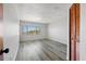 Bright bedroom with large window and grey laminate floors at 320 Windrush Blvd # 4, Indian Rocks Beach, FL 33785