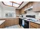 Kitchen with wood cabinets, white appliances, and a skylight at 320 Windrush Blvd # 4, Indian Rocks Beach, FL 33785