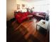 Living room with red couches and wood floors at 4215 E Bay Dr # 1103D, Clearwater, FL 33764