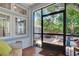 Cozy screened porch with wicker furniture, overlooking backyard at 2827 11Th N Ave, St Petersburg, FL 33713