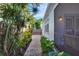 Landscaped side yard with brick pathway leading to the back at 2827 11Th N Ave, St Petersburg, FL 33713