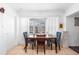 Dining area with wooden table and blue patterned chairs at 5534 Atlantic N Ave, St Petersburg, FL 33703