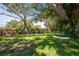 Large backyard with grassy area, mature trees, and a surfboard swing at 5534 Atlantic N Ave, St Petersburg, FL 33703