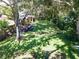 Large grassy backyard with firepit and mature trees at 5534 Atlantic N Ave, St Petersburg, FL 33703