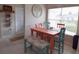 Kitchen with orange table, teal bench, and white cabinets at 29407 Princeville Dr, San Antonio, FL 33576