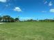 Expansive green field with palm trees and a clear sky at 5521 Bay Blvd # 201, Port Richey, FL 34668