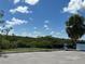 Empty parking lot next to a calm body of water and mangrove trees at 5521 Bay Blvd # 201, Port Richey, FL 34668
